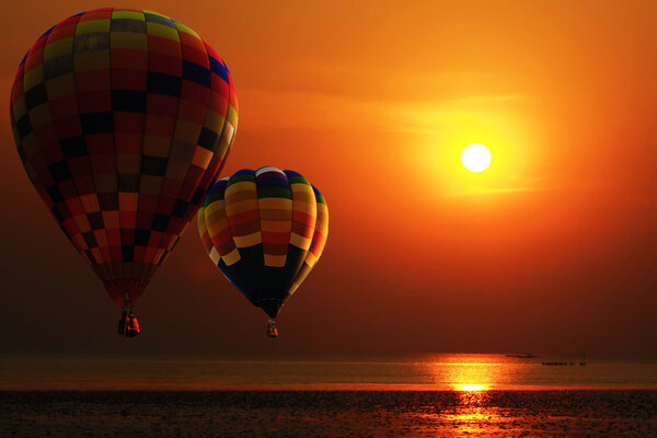 Hot air balloon over the beach in sunrise. Travel concept.