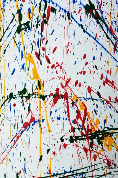Colorful paint splatter  on a white cloth.