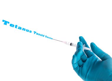 Tetanoz toksoidi aşı metin üzerinde beyaz izole mavi eldiven tutarak şırıngada el