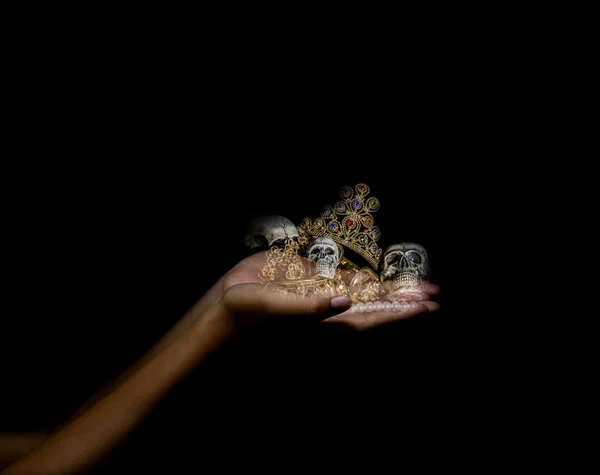 Holding hand treasure with skull