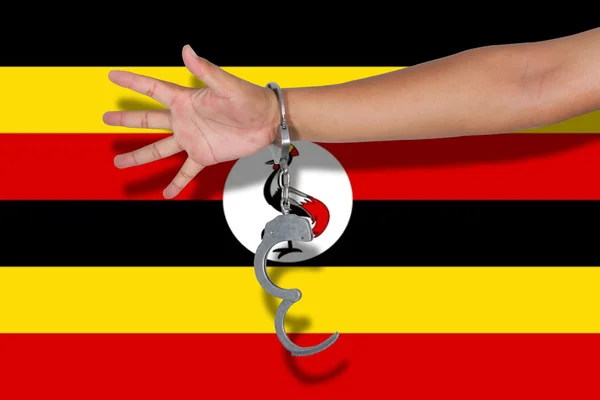 Χειροπέδες Χέρι Στην Ουγκάντα Σημαία — Φωτογραφία Αρχείου
