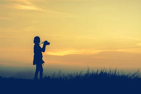 stock image boys playing football at sunset. silhouette concept