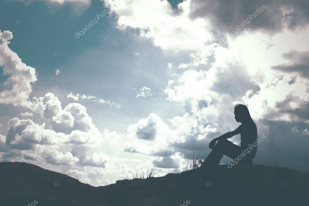 Sad and depressed woman sitting alone