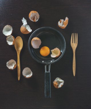 ahşap masa üzerinde bir demir tavada yumurta