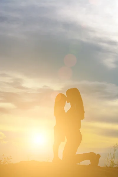 Silhouette Junge Mutter Küsst Die Stirn Seiner Tochter — Stockfoto