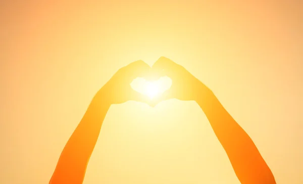 Silhouette hand heart shape with sun light — Stock Photo, Image