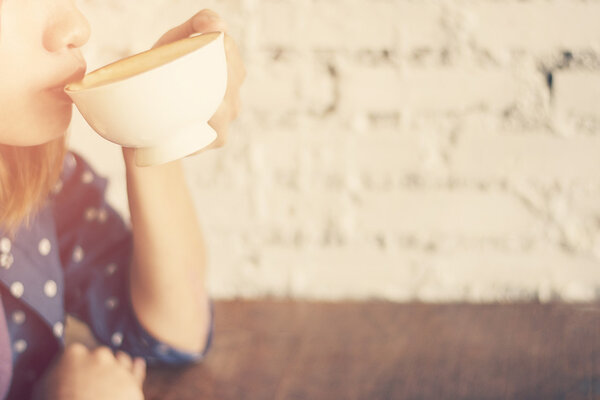 Beautiful women with cup of coffee on white background