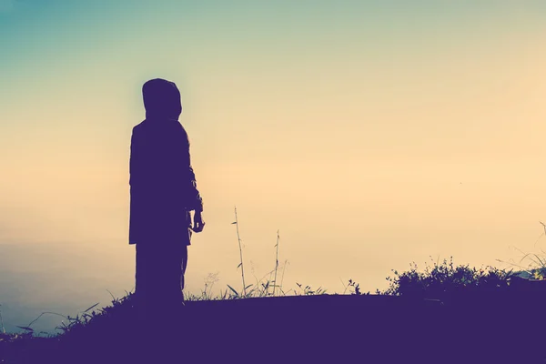 Silhouette of Old woman on the mountain waiting someone