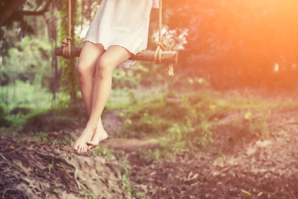 Hermosas mujeres están sentadas columpios muy feliz . — Foto de Stock