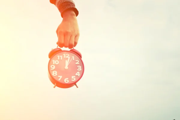 Hands holding an red alarm clock, time concept — Stock Photo, Image