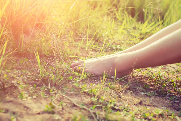 Feet of a young woman lying in a grass — Stock Photo, Image
