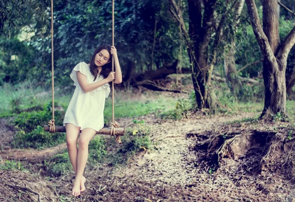 Beautiful women are sitting swings waiting someone.dream soft st — Stock Photo, Image