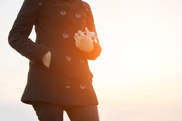 Woman hands carrying retro camera with black coat in the park — Stock Photo, Image