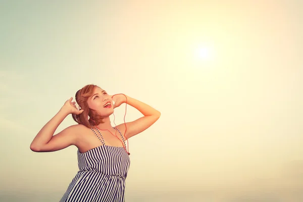 Beautiful sexy woman listening music from smartphone in the flow — Stock Photo, Image