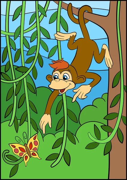 Küçük sevimli maymun ağaç üzerinde asılı ve butterfly'görünüyor