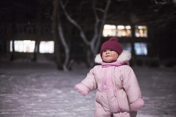 Cute adorable baby sit on snow in winter park holding — Stock Photo, Image