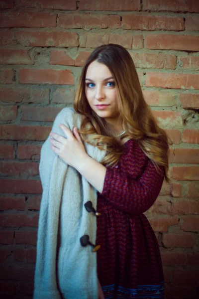 Beautiful girl portrait white sweater brick background — Stock Photo, Image