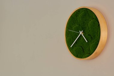 Duvardaki fotoğraf saati, yuvarlak ahşap saat, yeşil ottan yapılmış kadran..