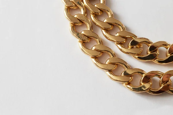 gold chain on white background close-up, wealth luxury