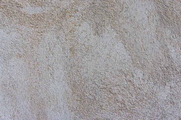 コンクリートの灰色の粗い壁の滑らかなテクスチャに花崗岩のチップが含まれています — ストック写真