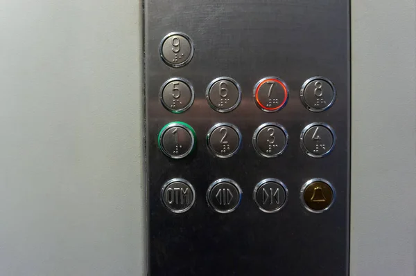 metal buttons in the passenger elevator car from 1 to 9 of the elevator close-up