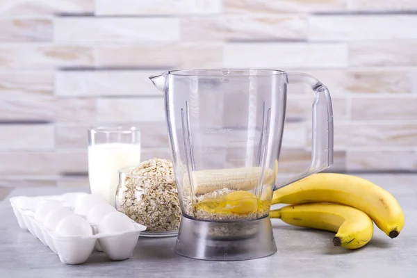 Oat pancakes with banana. Step by step cooking process. Ingredients top view. Bananas, milk, eggs, oats, salt. Wooden table background. Copy space. — Stock Image Oat Pancakes Banana Step Step Cooking Process Ingredients Top View Royalty Free Stock Images