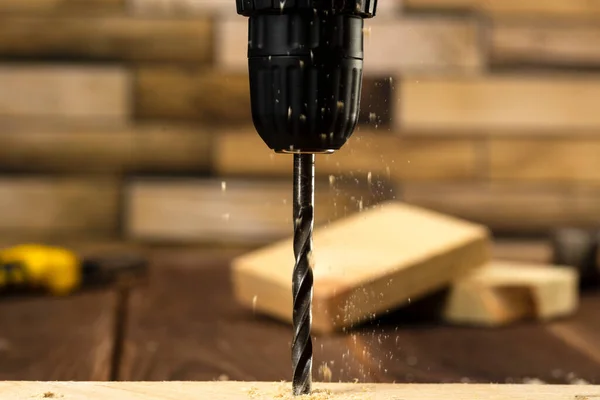 Closeup of wood drill bit with sawdust.