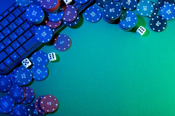 Online gaming platform, casino and gambling business. Dice on laptop keyboard on green background.