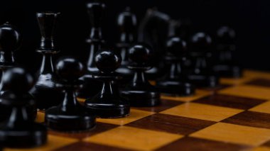 Satranç tahtasındaki siyah satranç taşları. Masada siyah piyon ordusu var..