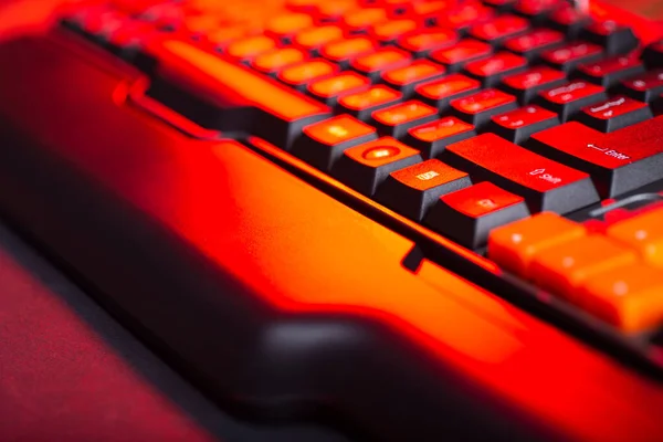 Gaming keyboard from computer close-up with color backlight.