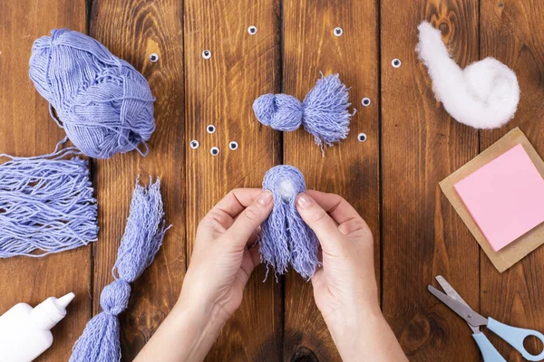 How to make a cute thread bird for decoration. Children\'s art project. DIY concept. Hands are made from blue threads of a blue dove. Step-by-step photo instructions.