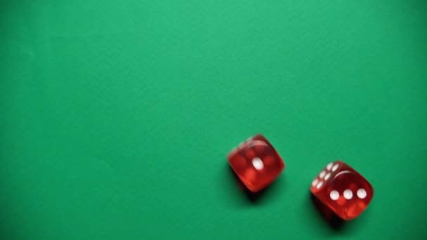 Red dice falling on green table. The Numbers 3 and 1 Appear on the Dice. — Stock Video