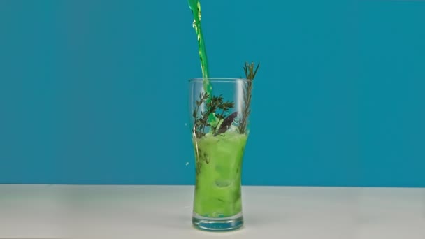 Slow motion groene limonade wordt gegoten in een glas met ijs Rechtenvrije Stockvideo's