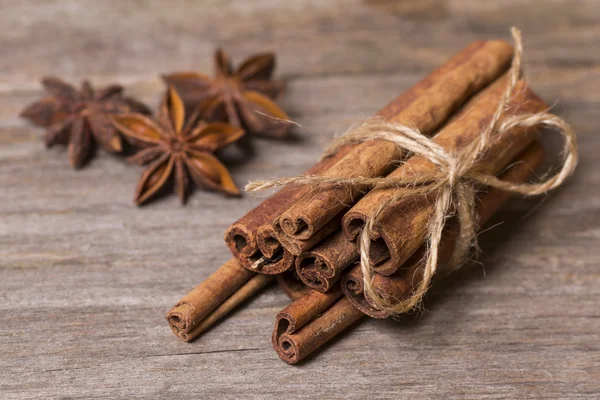 Cinnamon sticks close up on wooden background Royalty Free Stock Photos