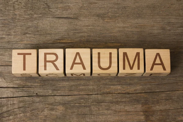 Trauma word written on wooden cubes — Stock Photo, Image