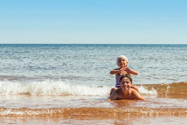 Little girl and boy playing on the beach — Stock Photo, Image