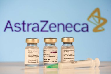 San Sebastian, Gipuzkoa, Spain; 03 February 2021.Three Covid-19  Astrazeneca vaccine vials with astrazeneca logotype background to inject medical professionals and people at risk. SARS-CoV-2 vaccination treatment. Copy space. clipart