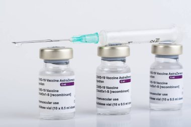 San Sebastian, Gipuzkoa, Spain; 03 February 2021.Three Covid-19 vaccine vials with white background to inject medical professionals and people at risk. SARS-CoV-2 vaccination treatment. Copy space. clipart