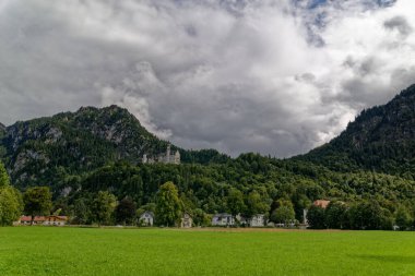 Bulutlu bir sonbahar günü Alplerin eteğindeki bir şatonun yanında.