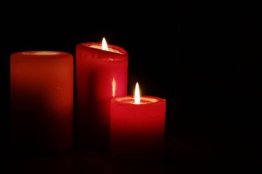  Kırmızı mumlar Karanlığı Ilık bir parıltıyla aydınlatıyor 