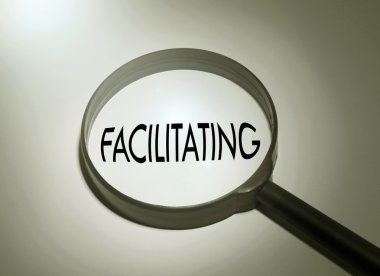 Magnifying glass with the word facilitating clipart