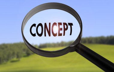 Bulanık doğa arka plan üzerinde kelime kavramı ile büyüteç. Kavram kavramının aranması