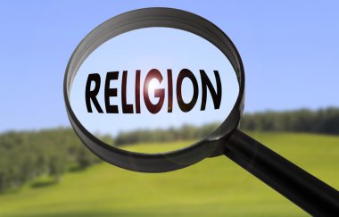 Magnifying glass with the word religion on blurred nature background. Searching religion concept clipart