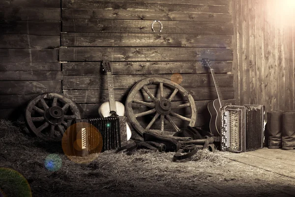 Old shed in the morning at sunrise. Musical instruments in the hayloft. Guitar and harmonica — Stock Photo, Image