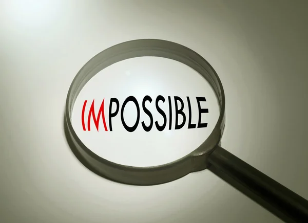 Magnifying glass with the word impossible. Searching impossible — Stock Photo, Image