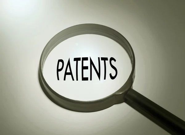 Büyüteç kelime patent ile — Stok fotoğraf
