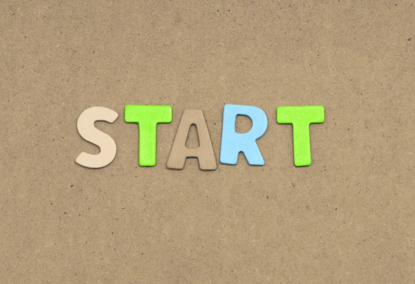 Start text on brown background — Stock Photo, Image