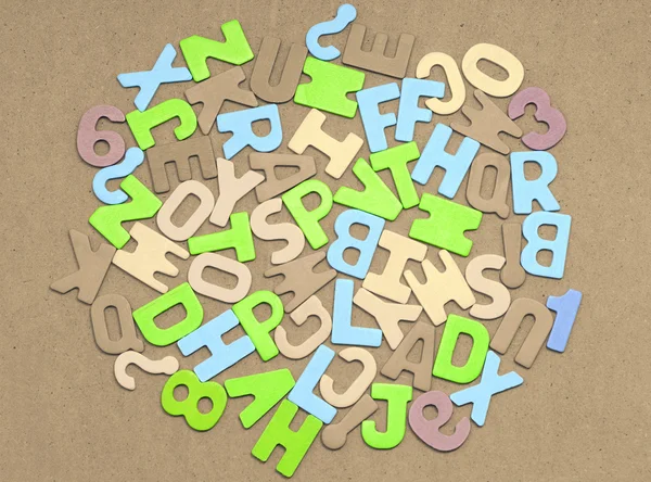 Alphabet on brown background — Stock Photo, Image