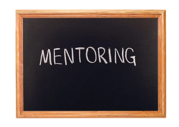 Written in white chalk on a blackboard - mentoring — Stock Photo, Image