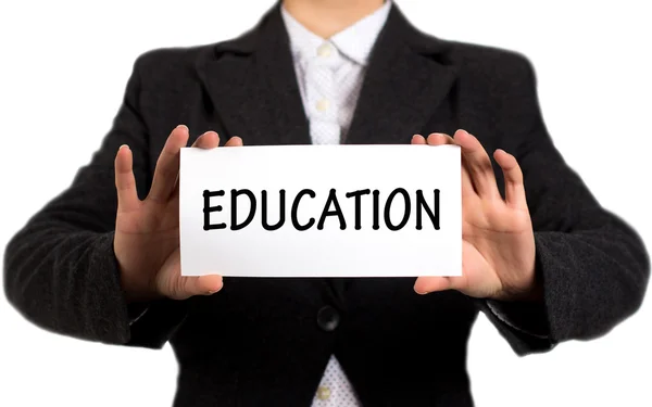 Businesswoman in a black jacket and a white shirt shows a card with the inscription education — Stock fotografie